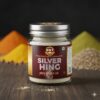 Silver Hing jar by Shree Girraj Traders with raw spices background, authentic Hathras asafoetida for Indian cooking